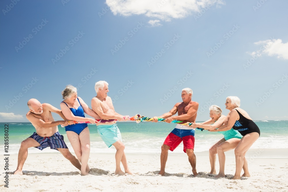Senior friends playing tug of war Senior friends playing tug of war