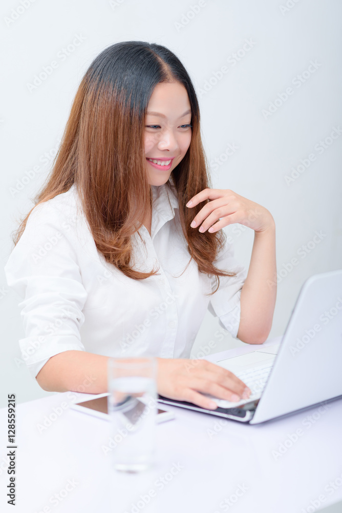 Young business woman using laptop at desk. Young business woman using laptop at desk.