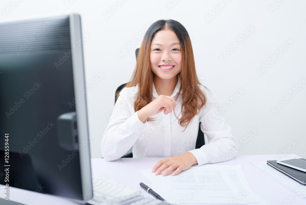 Young businesswoman working at her workplace. Young businesswoman working at her workplace.