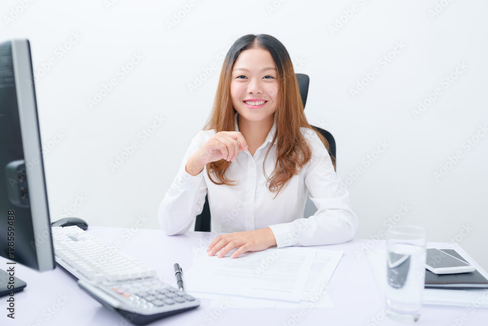 Young businesswoman working at her workplace. Young businesswoman working at her workplace.