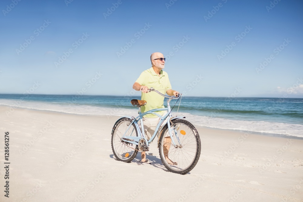 Smiling senior man with bike