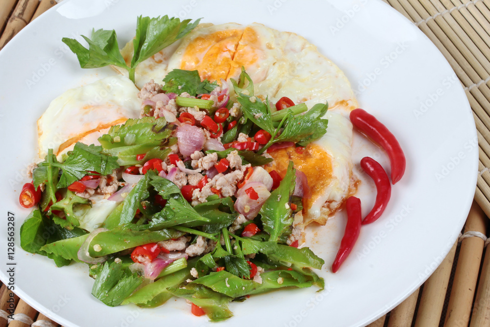 Thai food,Spicy wing bean with pork topped fried egg. Thai food,Spicy wing bean with pork topped fried egg.