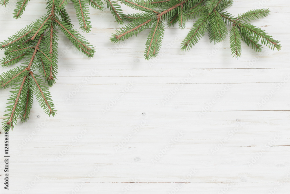 Christmas fir branches on white wooden background Christmas fir branches on white wooden background