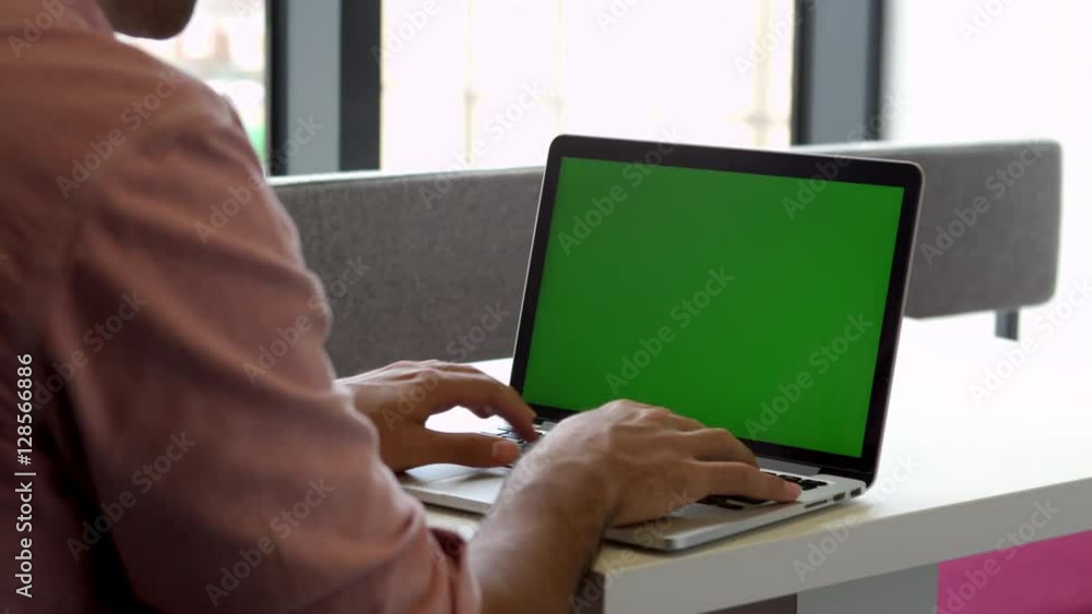 View From Behind Of Male Student Using Laptop Shot On R3D View From Behind Of Male Student Using Laptop Shot On R3D