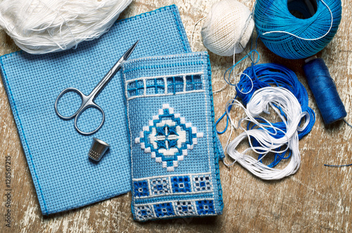 Billede på lærred Hardanger embroidery blue and white colors with instruments
