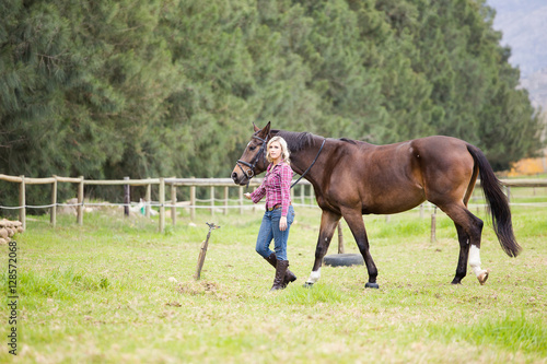 Beautiful elegance back woman cowgirl, riding a horse wearing bl