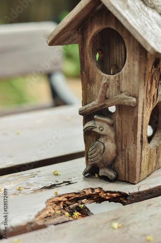 a close up of wooden bird house on wooden table