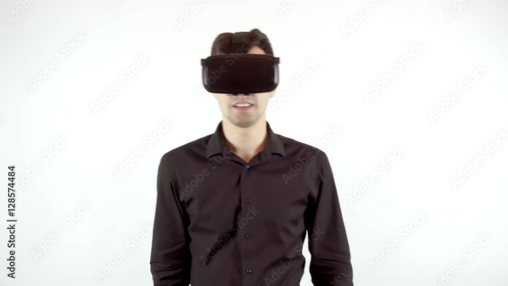 Man playing in virtual reality goggles. Studio video, white background Man playing in virtual reality goggles. Studio video, white background