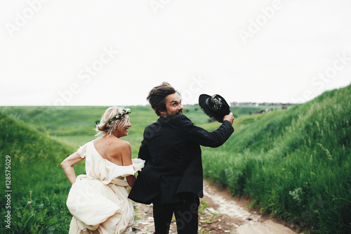 Funny running bride and groom