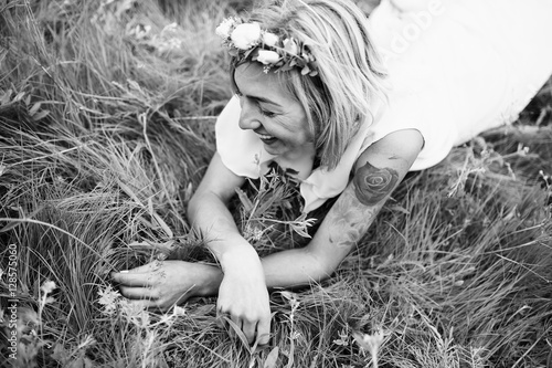 Smiling bride lay in grass