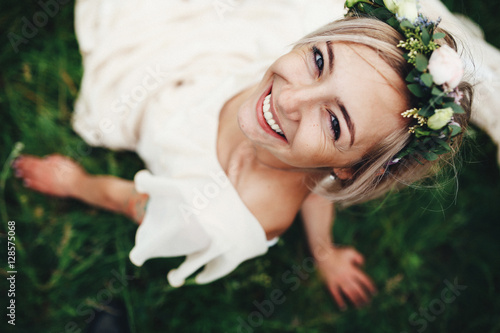 Pretty young girl in white dress and tiny wreath