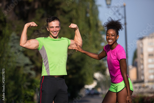 portrait of young multietnic jogging couple ready to run photo