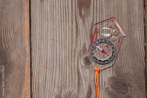 plastic compass over a wooden background photo