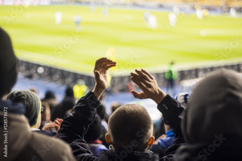 fans who clap their hands at the stadium photo