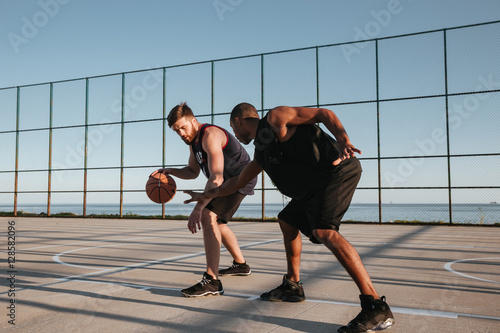 Two healthy basketball players at the playground