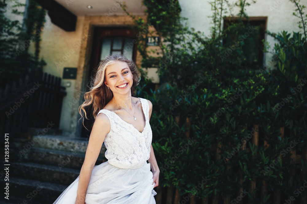 incredibly beautiful and happy girl sitting on the stairs incredibly beautiful and happy girl sitting on the stairs