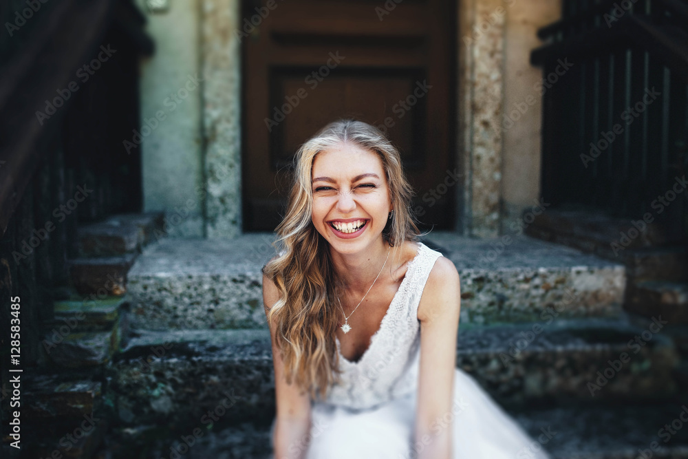incredibly beautiful and happy girl sitting on the stairs incredibly beautiful and happy girl sitting on the stairs