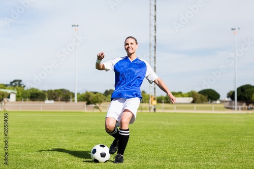Female football player practicing soccer