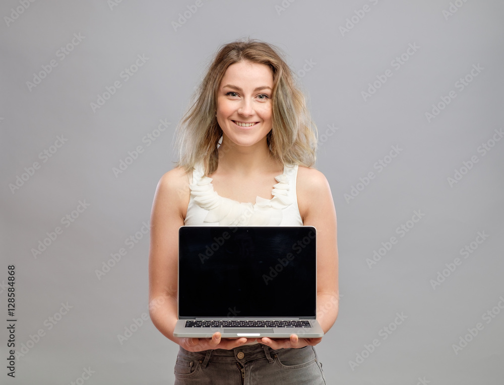 Woman showing blank laptop computer screen Woman showing blank laptop computer screen