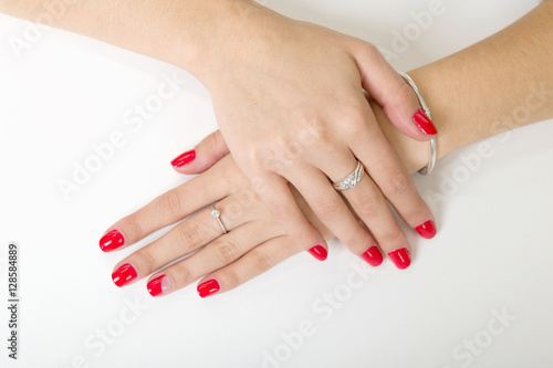 woman's hands with painted nails on a white background