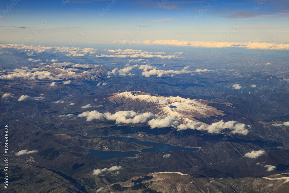 landscape from plane window of high mountain in italy after plan