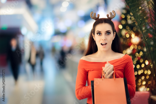 Funny Woman with Christmas Reindeer Horns Headband Shopping photo