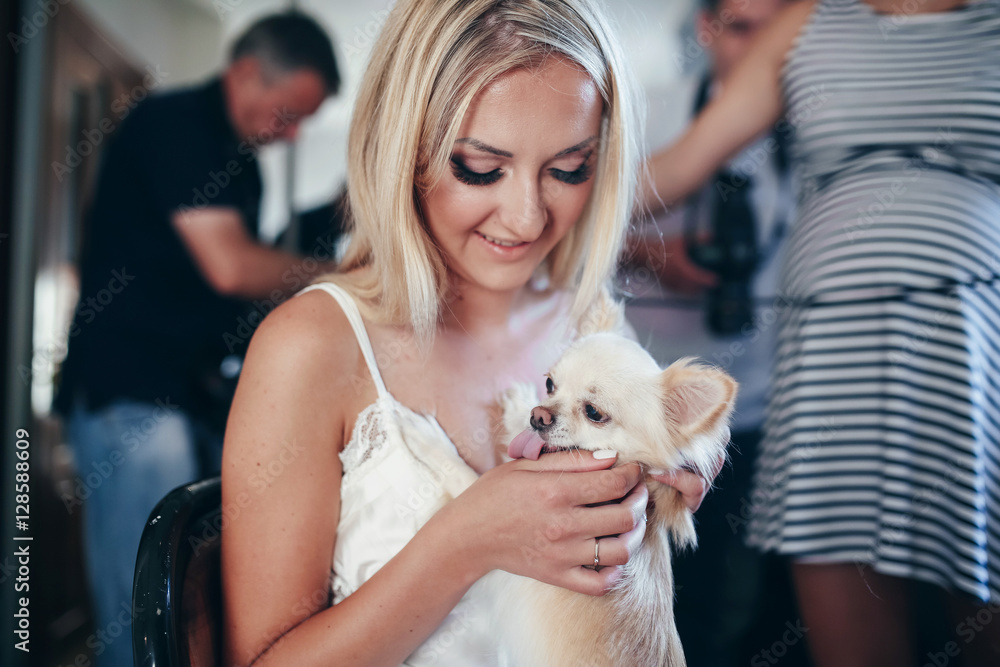 Beautiful bride is holding her lovely dog Beautiful bride is holding her lovely dog