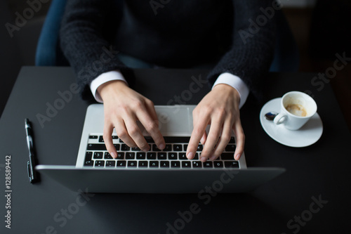 Woman's hands typing on notebook photo