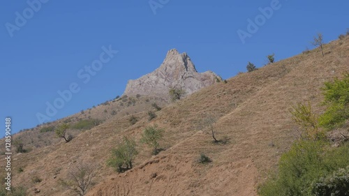 The sandy cliffs with rare green bushes. Crimea. Zelenogorie. photo