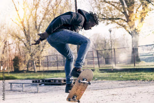 young skateboarder jumping on a ramp outdoor