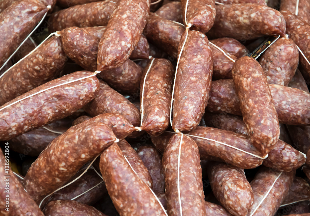Real italian sausage - Traditional craftsman preparation of sausage of pork salted and seasoned with spices and pepper. Food background, texture. Real italian sausage - Traditional craftsman preparation of sausage of pork salted and seasoned with spices and pepper. Food background, texture.