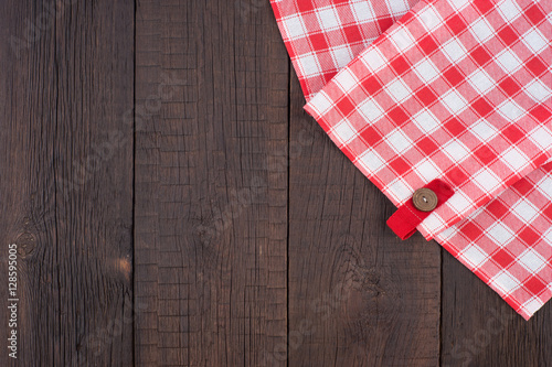 Rustic wooden boards with a red checkered tablecloth.