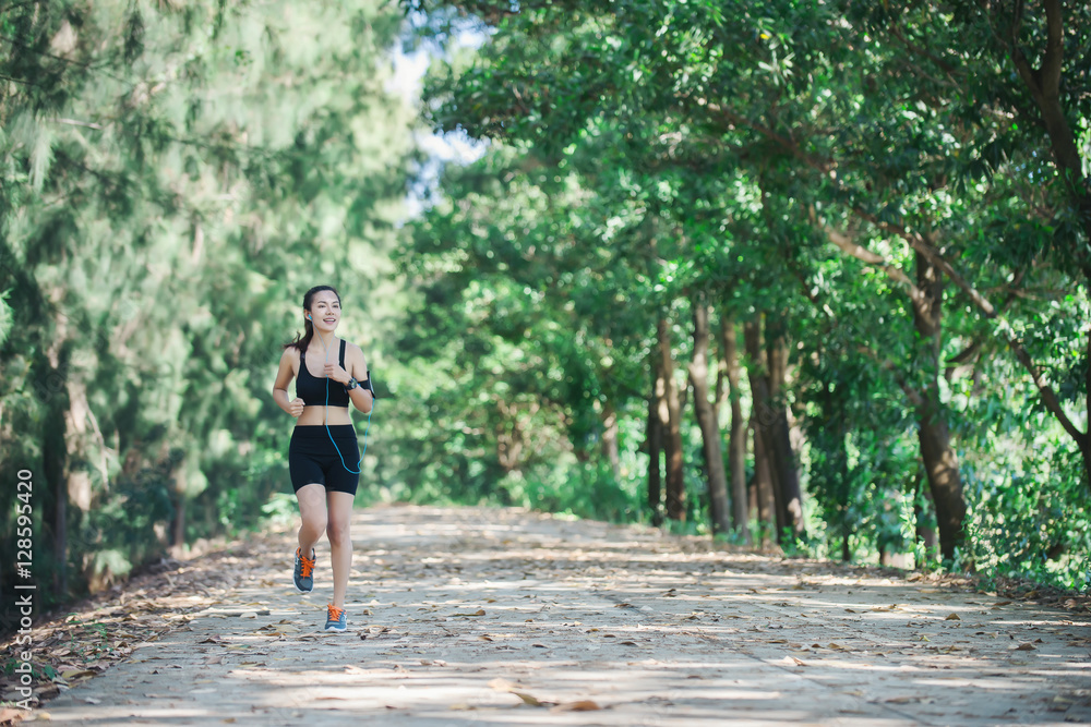 Young fitness woman jogging in park. Young fitness woman jogging in park.