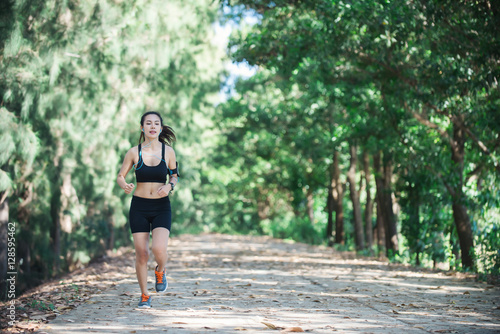 Young fitness woman jogging in park.