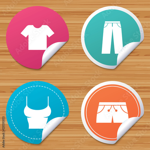 Round stickers or website banners. Clothes icons. T-shirt and pants with shorts signs. Swimming trunks symbol. Circle badges with bended corner. Vector