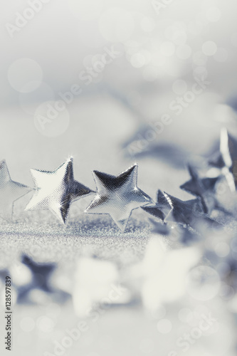 Christmas silver stars on sparkling background