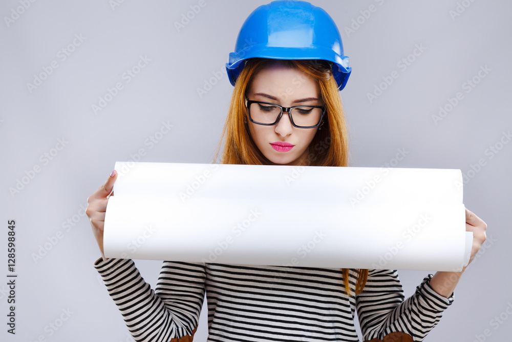 Girl in helmet and glasses looking at paper Girl in helmet and glasses looking at paper