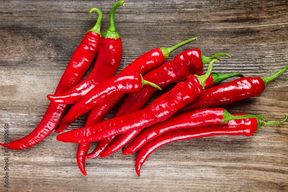 Red hot peppers on wooden background