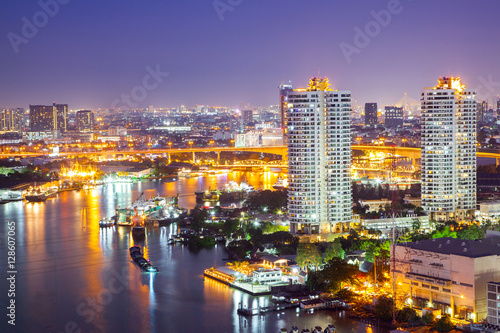 The City of Chaopraya river with light and reflection in twilight. Bangkok, Thailand