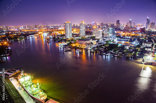 The City of Chaopraya river with light and reflection in twilight. Bangkok, Thailand