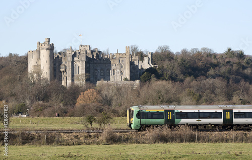 Canvas Print Passenger train passing a historic castle England UK November 2016 - A southern