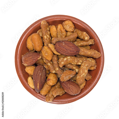 Energy trail mix blend in a small bowl top view isolated on a white background.