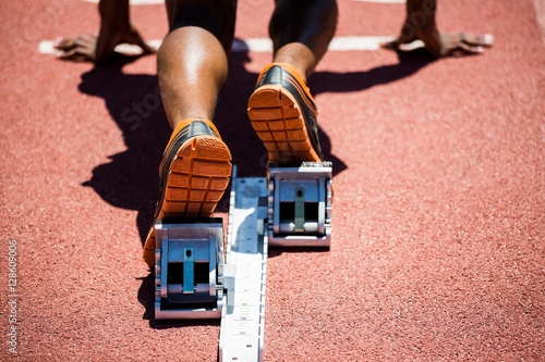 Feet of an athlete on a starting block about to run