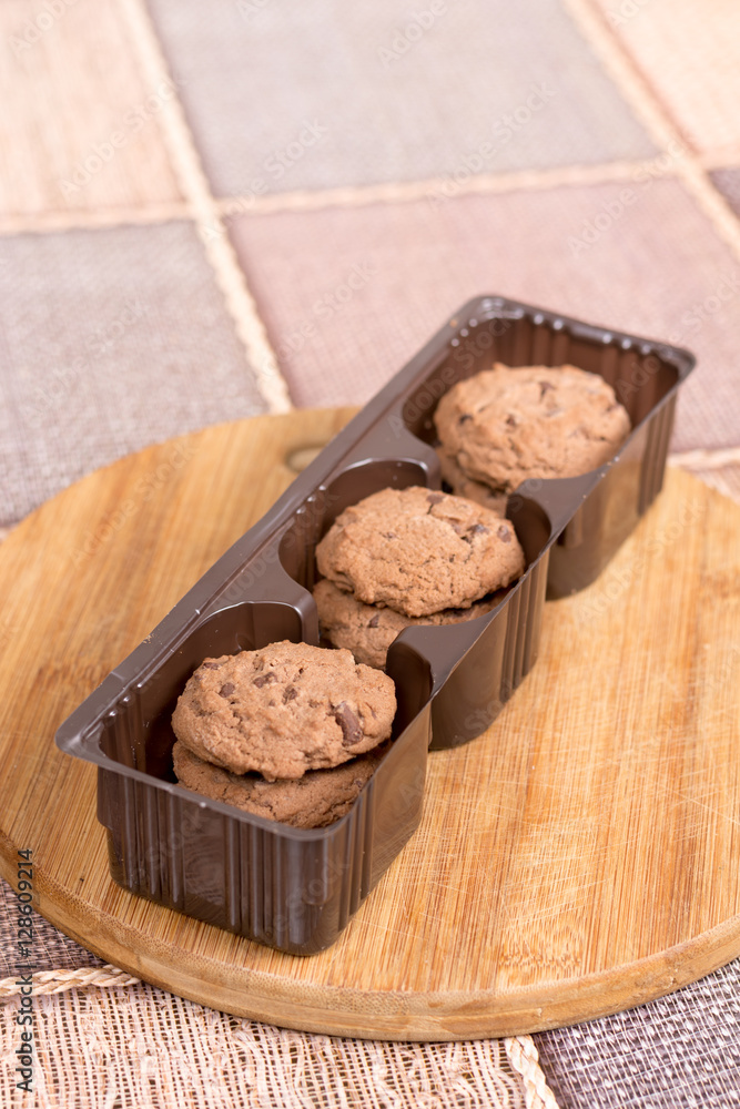 Fototapeta premium Brown biscuits cookies with chocolate in plastic packaging