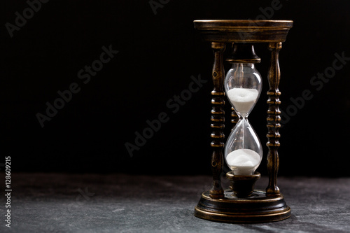 old hourglass on dark background