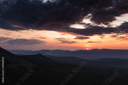 Beautiful mountain landscape at sunset. Natural sun and dark horizon © EdNurg