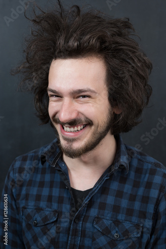 Portrait of a fashionable young man on dark background, chalkboa