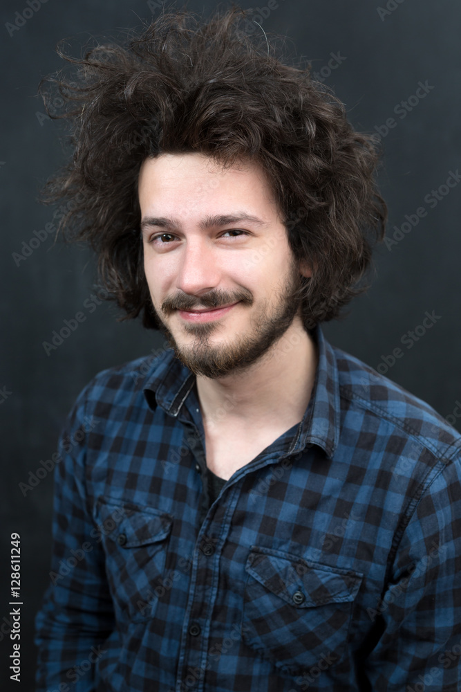 Fototapeta premium Portrait of a fashionable young man on dark background, chalkboa