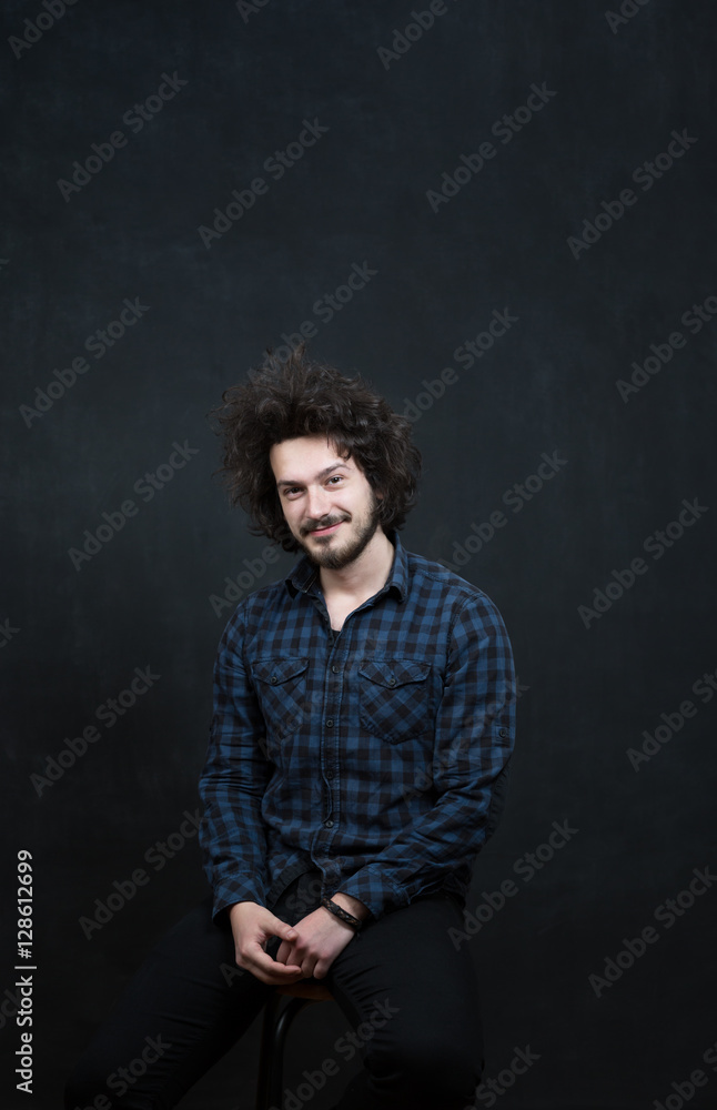 Portrait of a fashionable young man on dark background, chalkboa Portrait of a fashionable young man on dark background, chalkboa