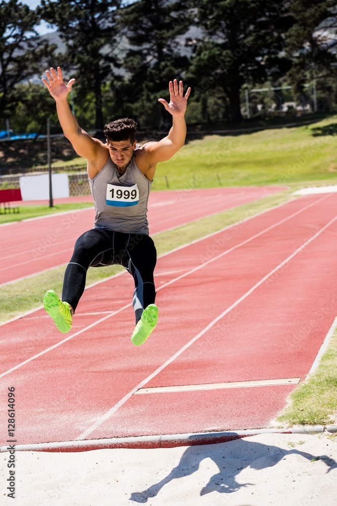 Fototapeta premium Athlete performing a long jump